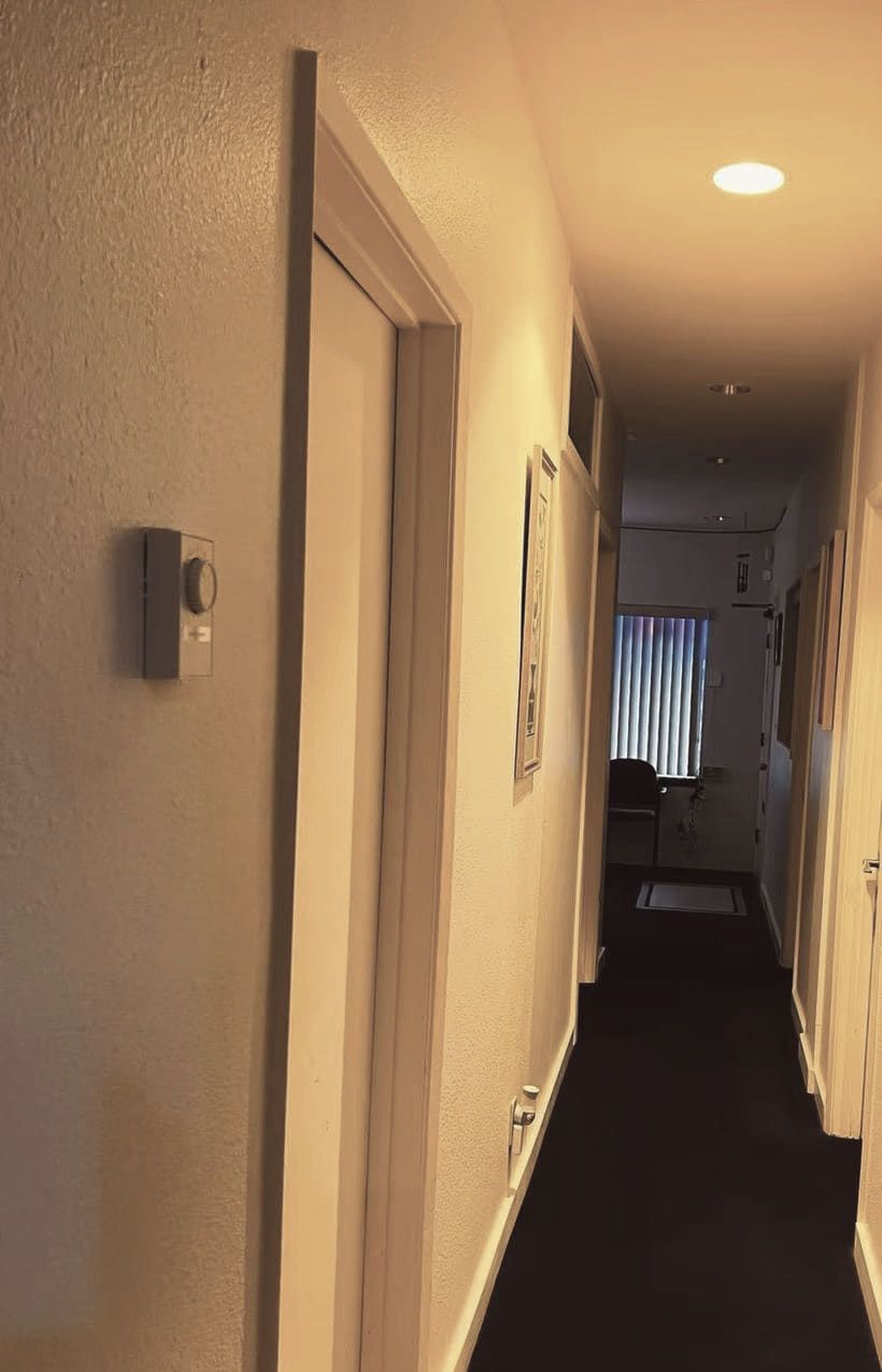Warm-lit corridor leading to the treatment rooms at Green Lake Spa